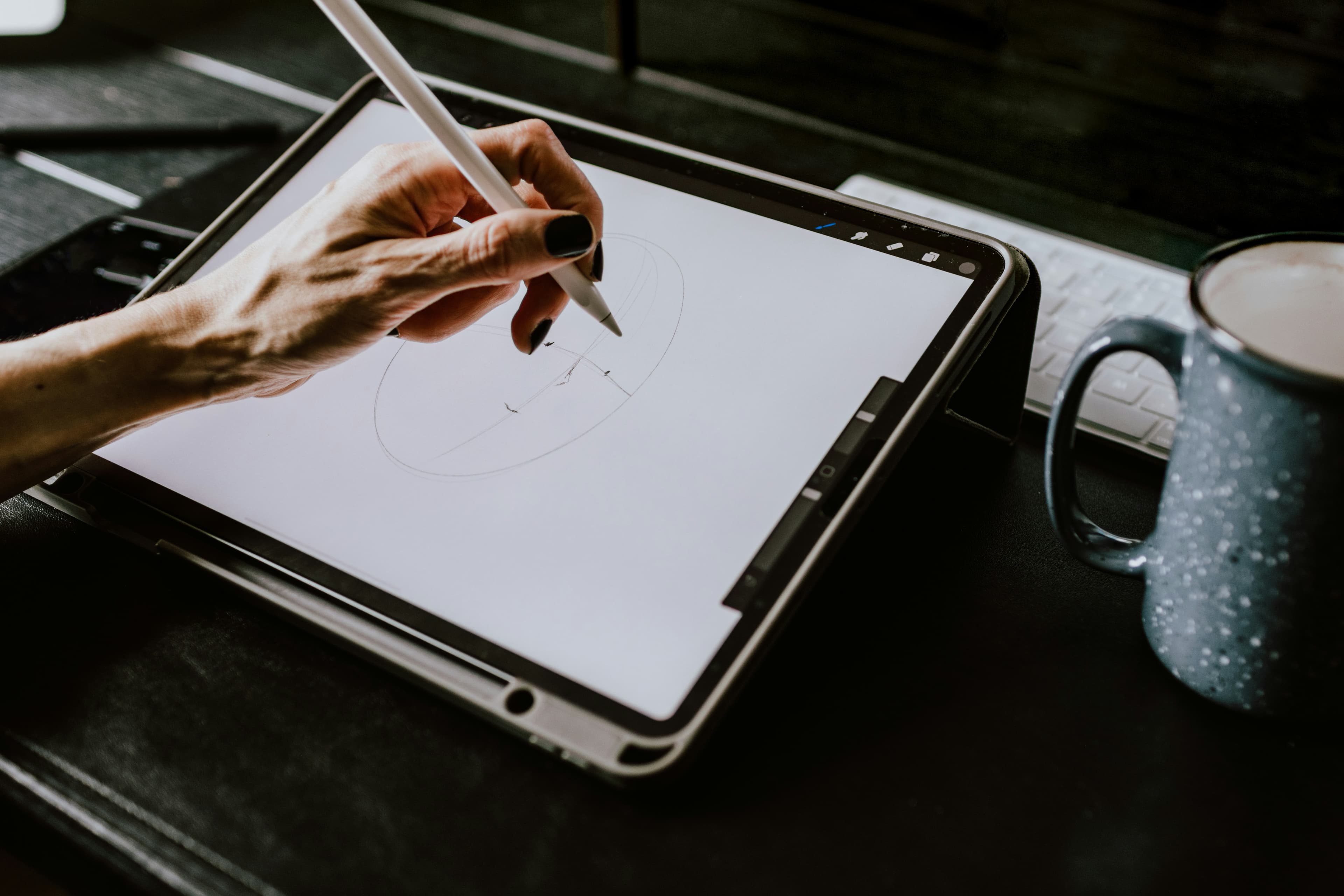 Artist sketching a tattoo design on a tablet