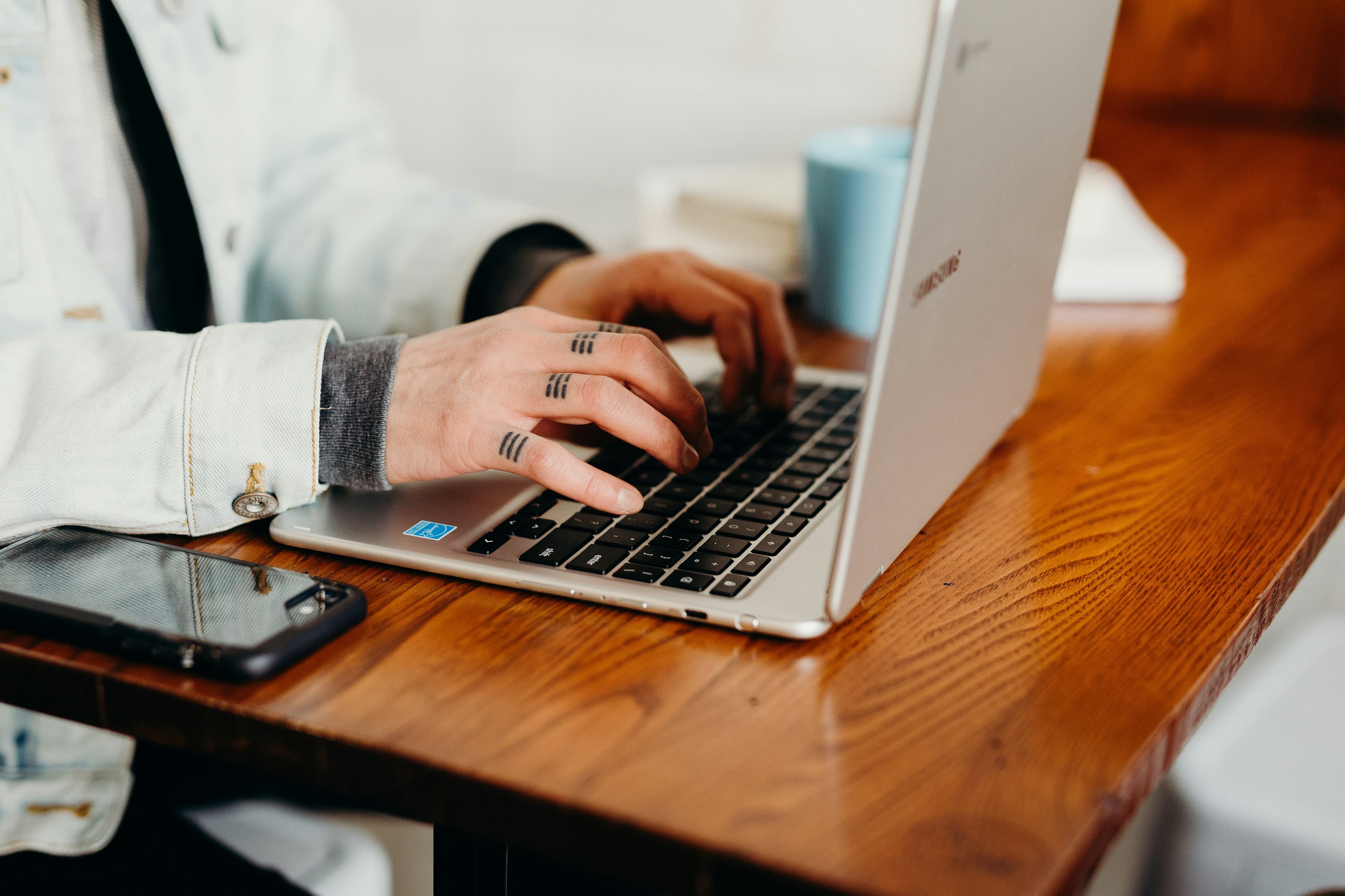 Person booking a tattoo appointment on a laptop